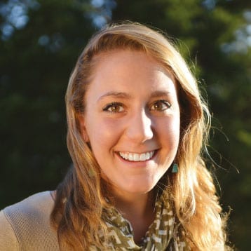 Smiling young woman with blonde hair.