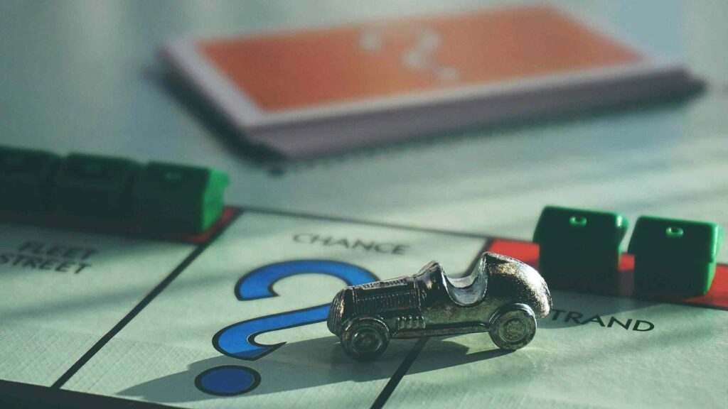 Monopoly Board with Metal Car Game Piece on it